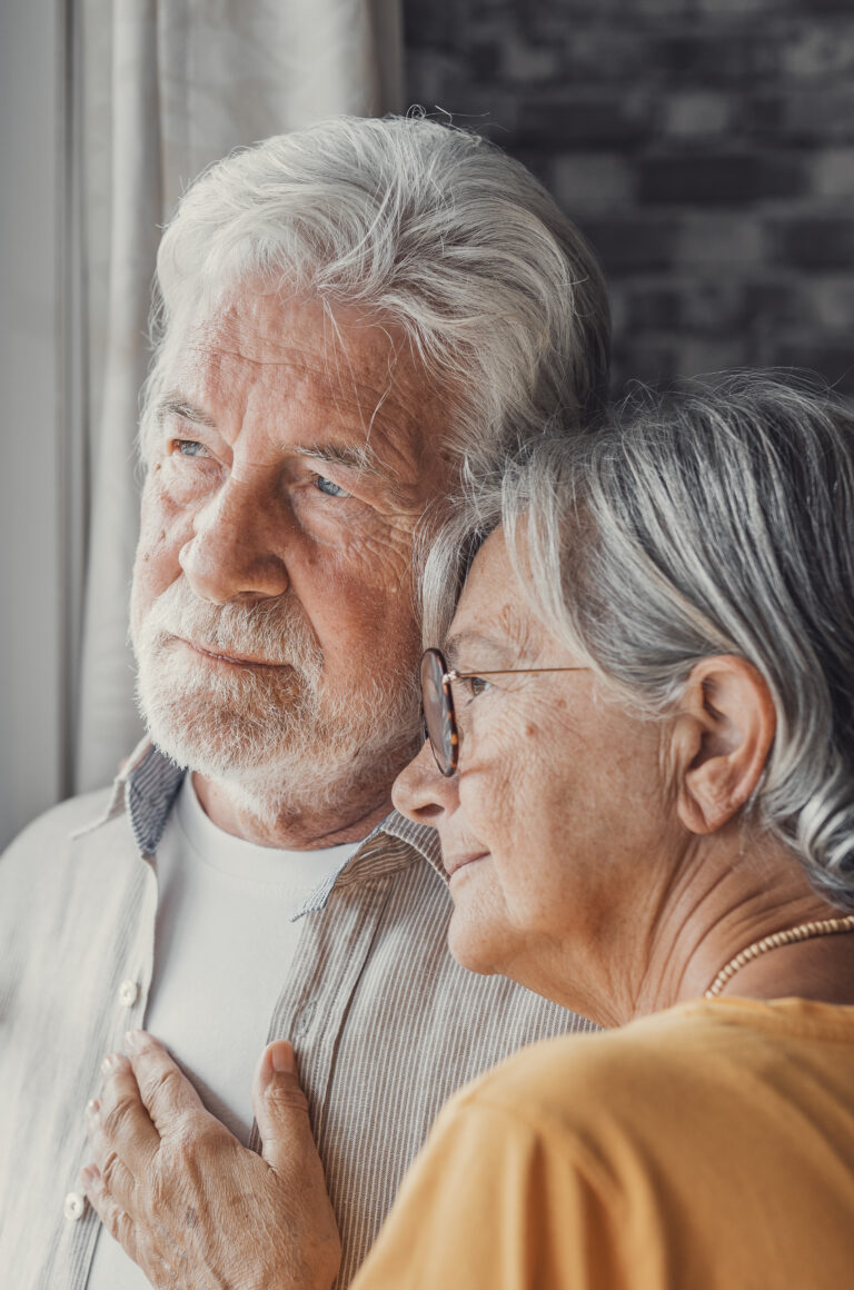 Elderly couple embracing at home, symbolizing love and companionship in senior care