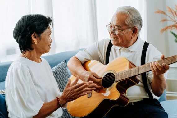 Elderly couple enjoying music together at home